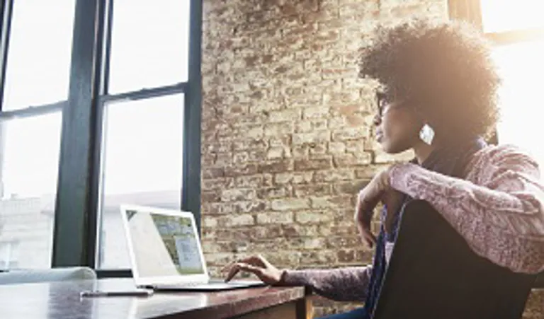 woman sitting at desk with a laptop 