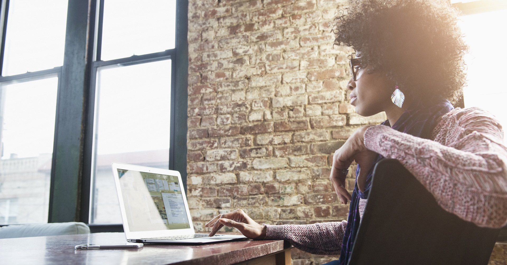 woman sitting at desk with a laptop 