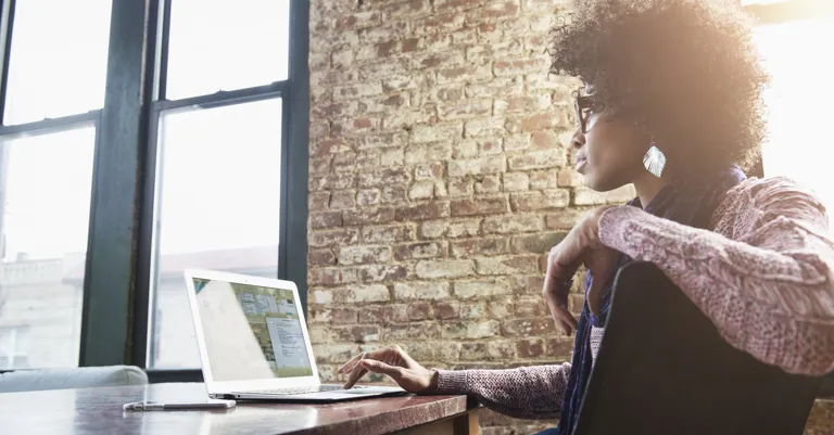 woman sitting at desk with a laptop