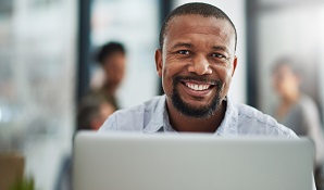 man sitting behind computer