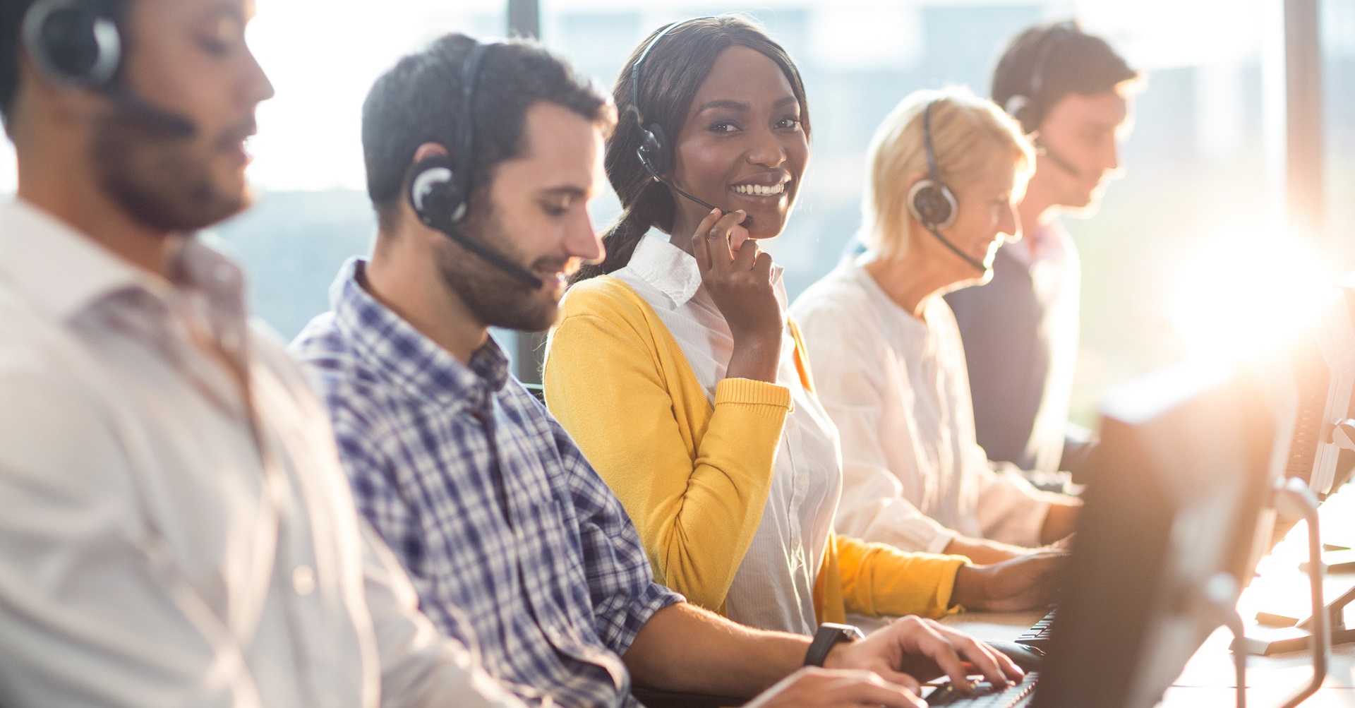 Woman smiling at camera in call centre