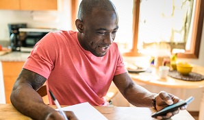 man sitting at desk with paper