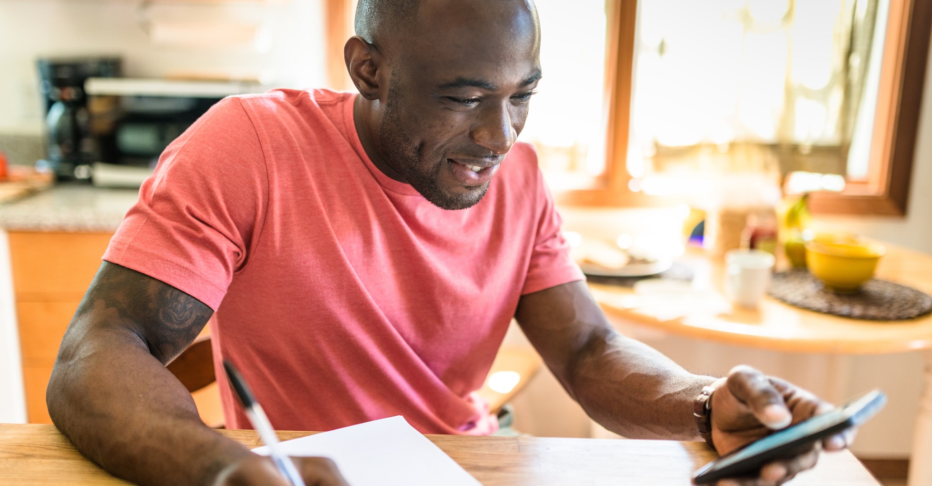 man sitting at desk with paper