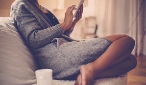 woman on couch with tablet