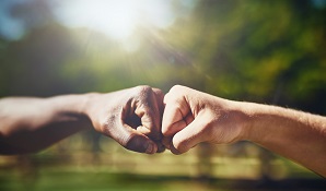 two hands joining in a fist bump