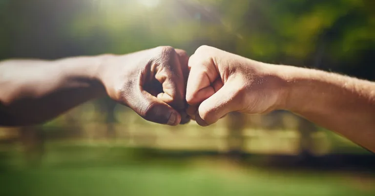two hands joining in a fist bump