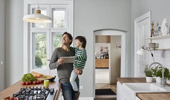 man with son standing in the kitchen