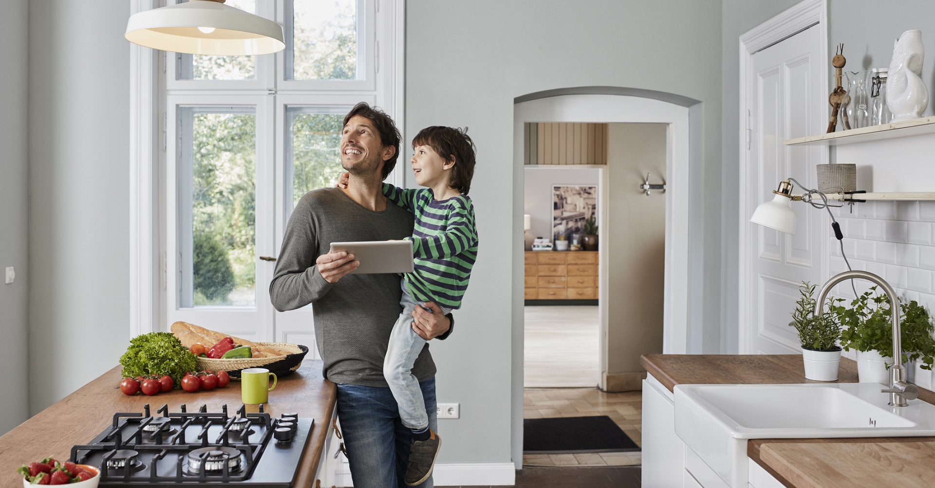 man with son standing in the kitchen