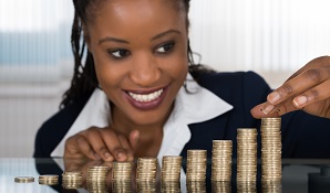 woman counting coins and putting them in a pile