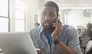 man sitting at laptop looking concerned