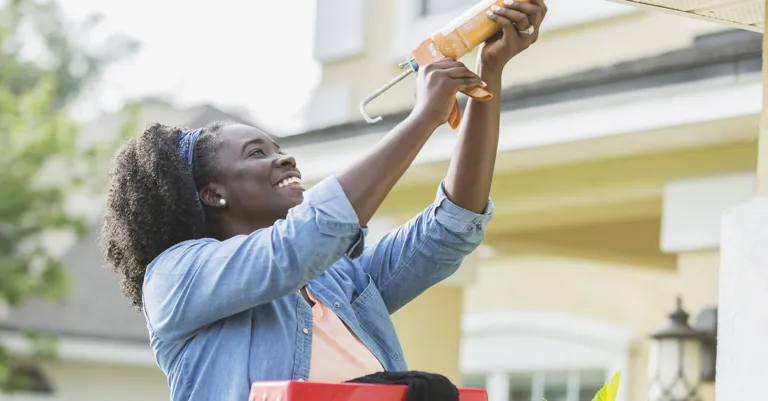 woman repairing roof at home