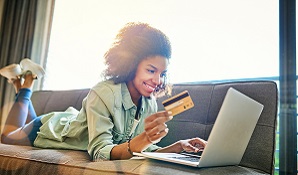 woman sitting on couch buying online