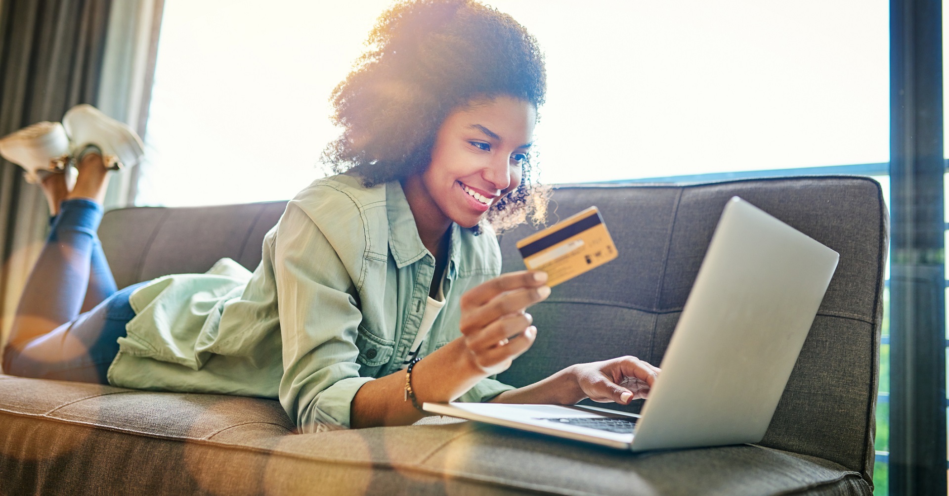 woman sitting on couch buying online