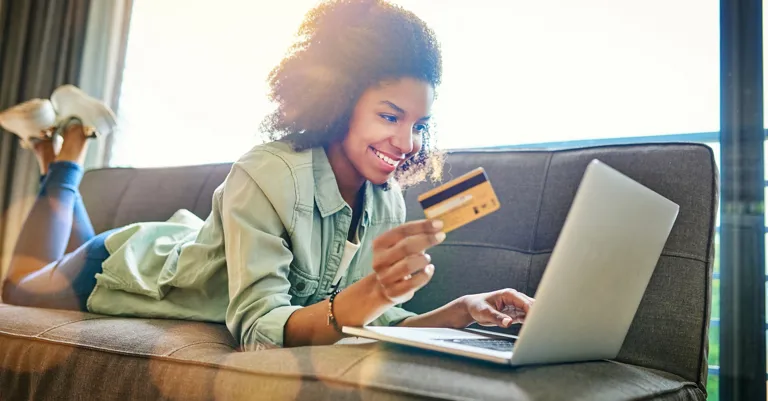 woman sitting on couch buying online