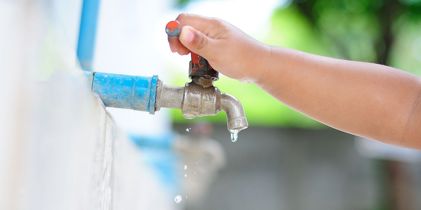 child hand closing tap