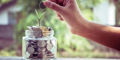 putting coins into a jar