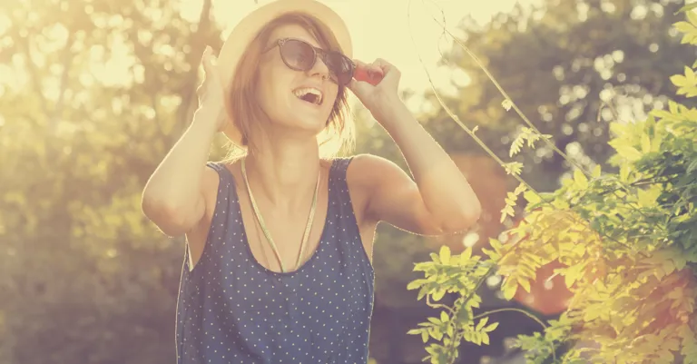 woman with hat smiling