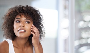 woman looking in mirror