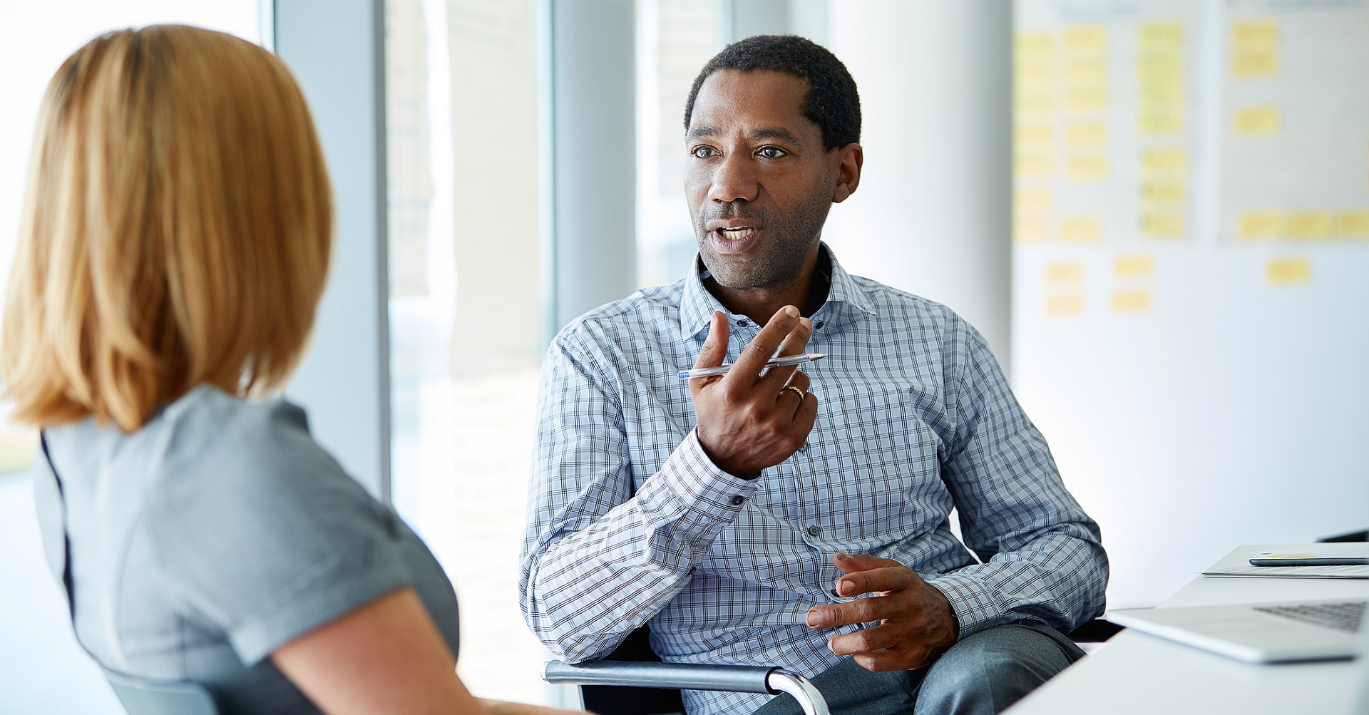 Man meeting with woman in office