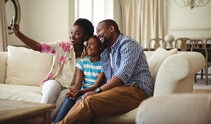 Family taking selfie on couch