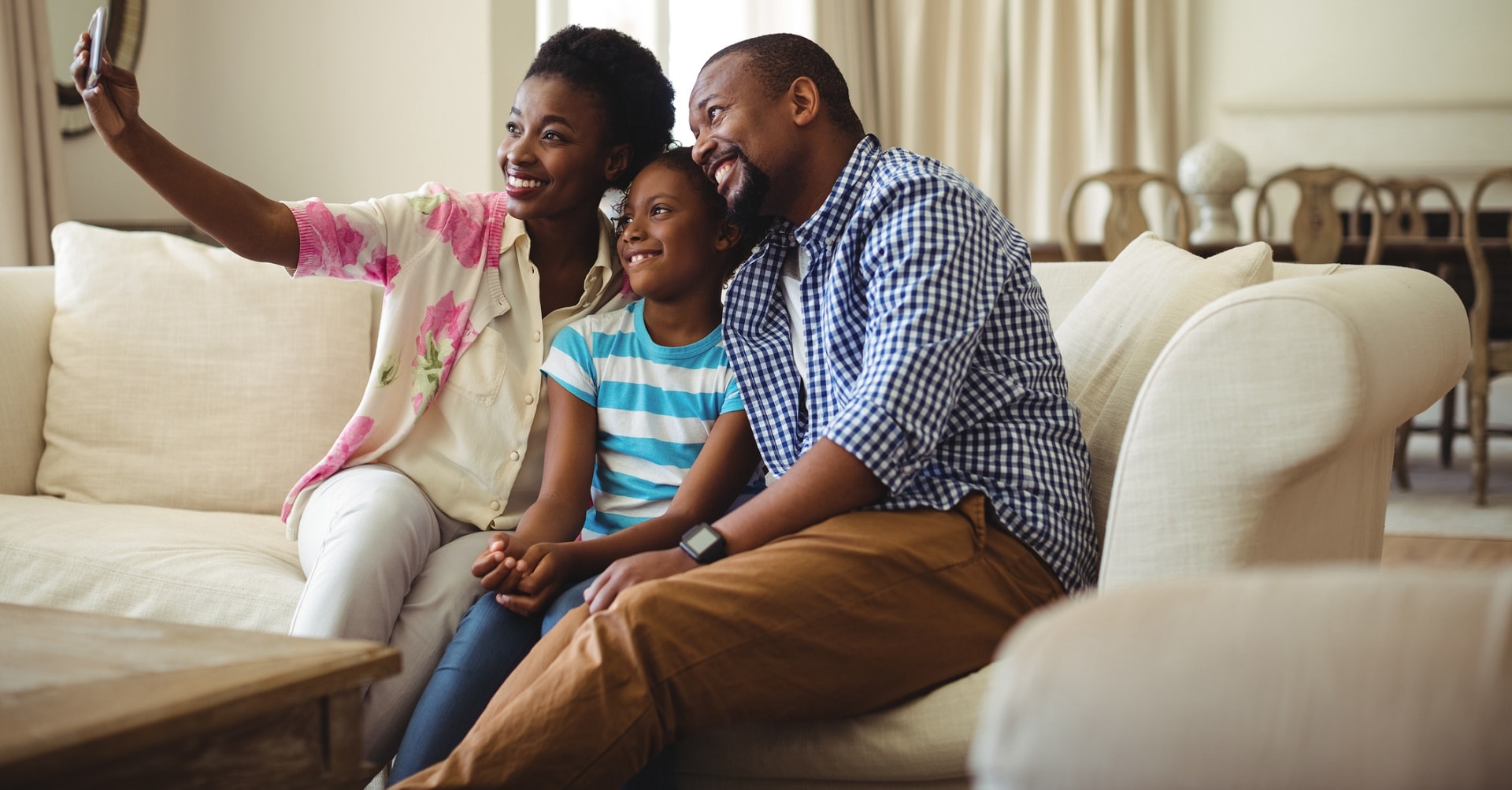 Family taking selfie on couch