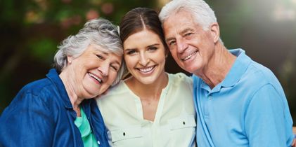 Young lady hugging elderly parents