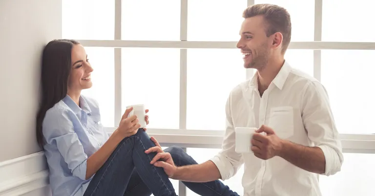 a couple taking over a cup of tea