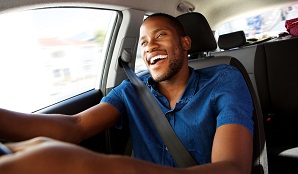 Happy man behind the wheel speeding