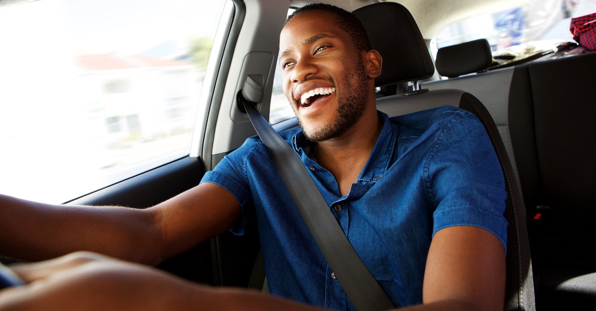 Happy man behind the wheel speeding