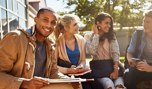 group of university students sitting outside