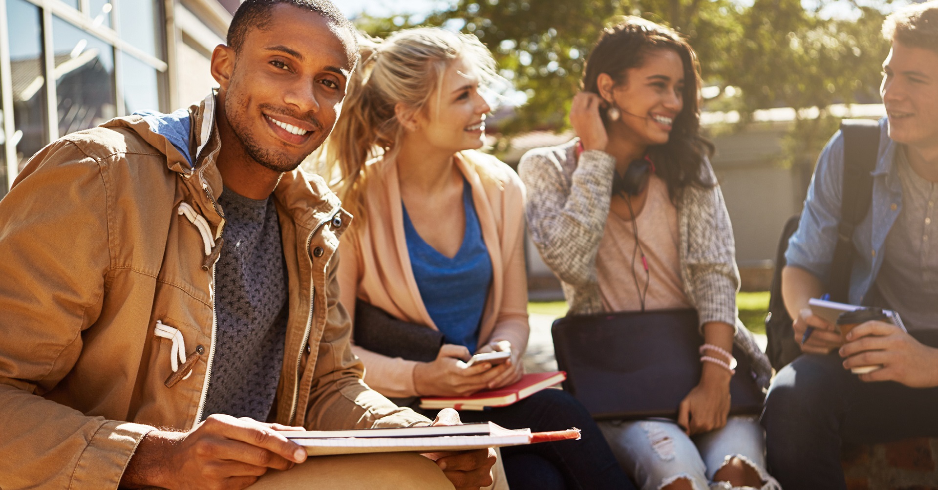 group of university students sitting outside