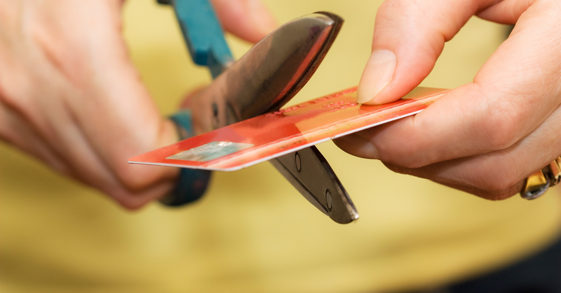 Woman cutting credit card