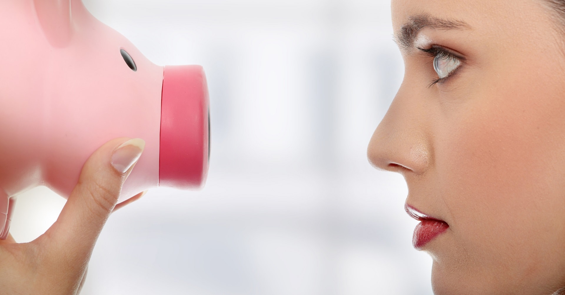 woman looking at piggy bank