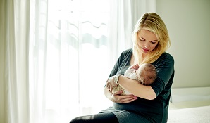 Woman holding new born baby