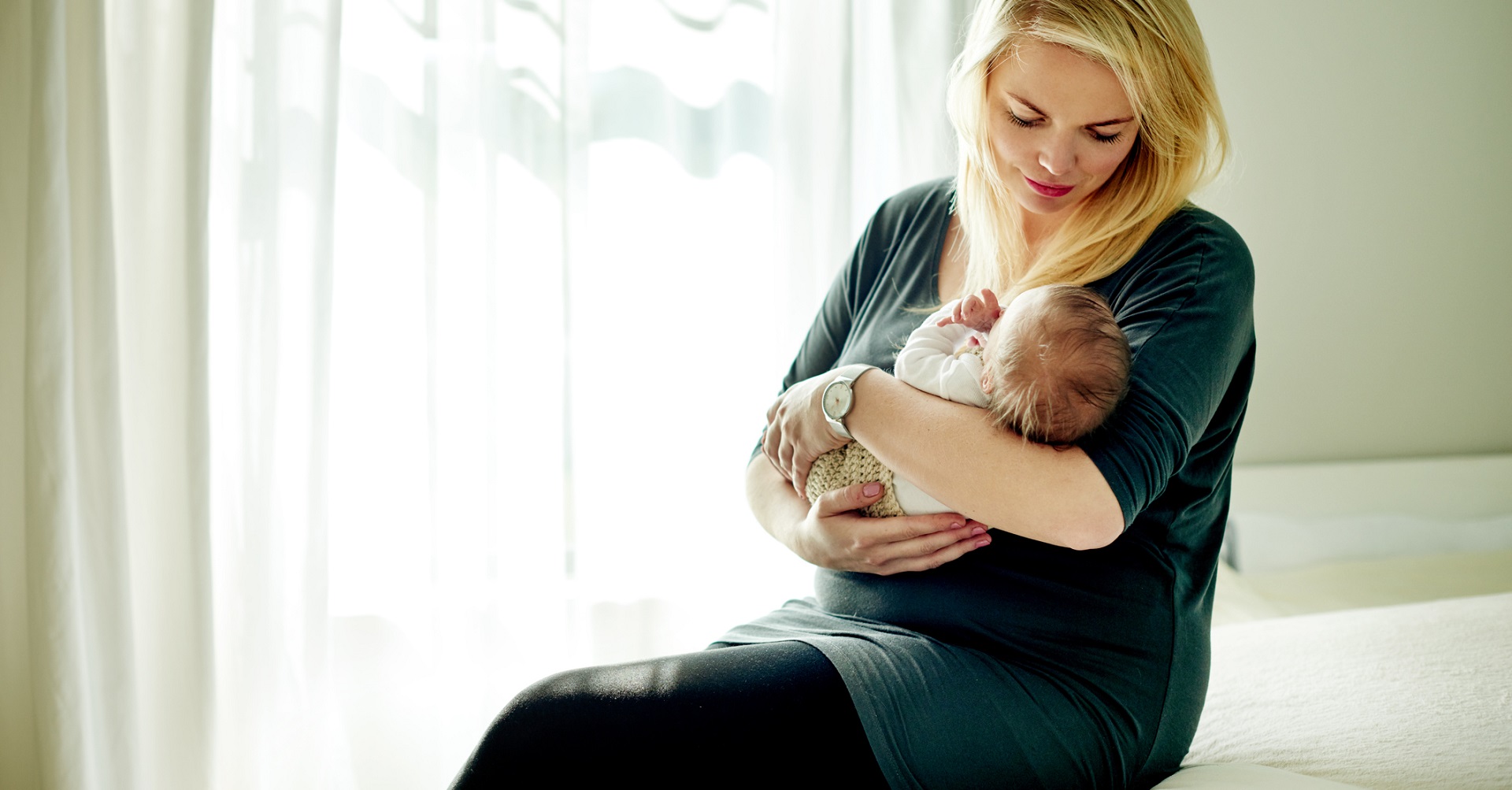 Woman holding new born baby