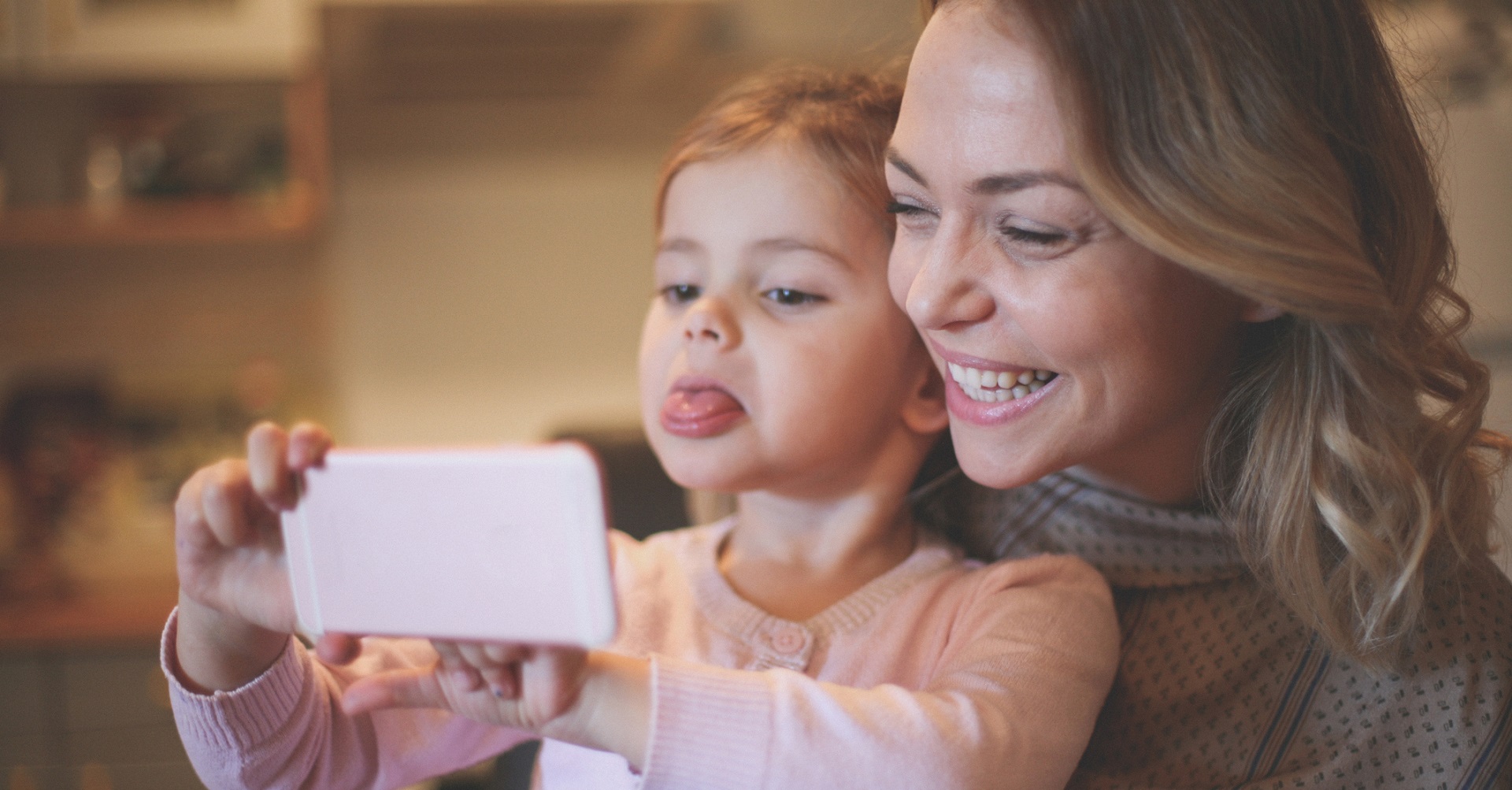 Woman sitting on bed with daughter