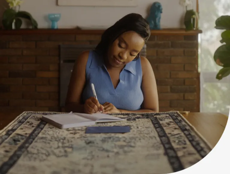 woman writing at table