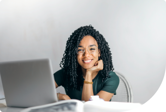 Lady smiling with laptop in front of her