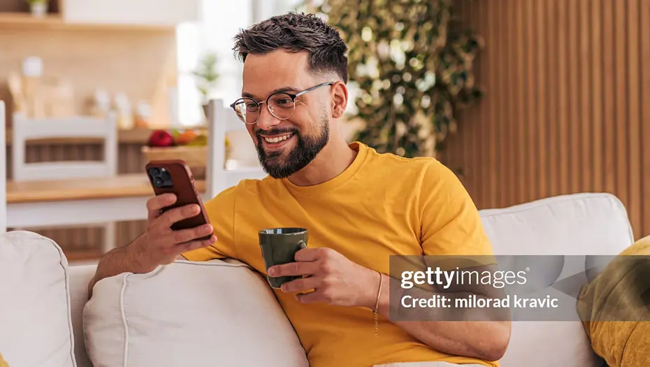 guy on couch using phone