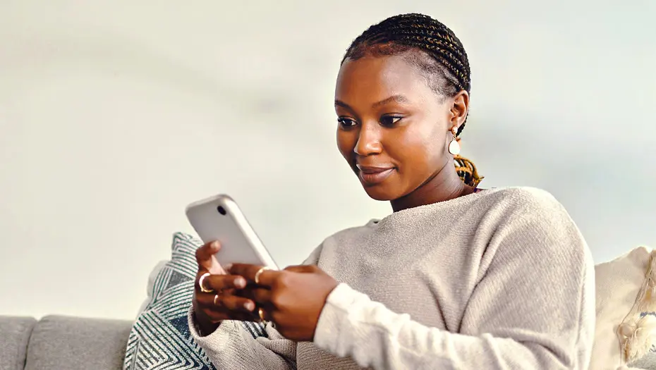 woman on couch using phone