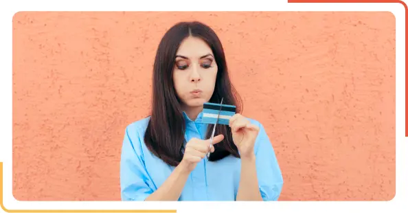 woman cutting bank card