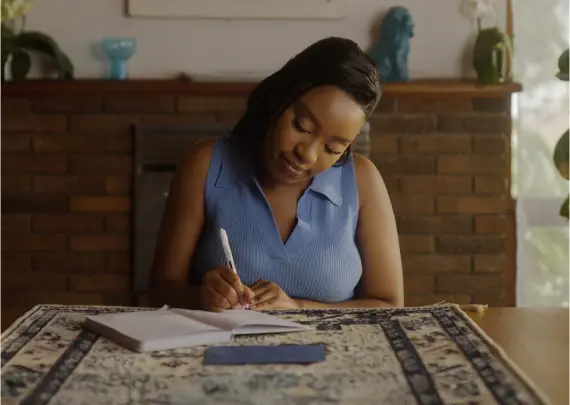 woman writing at table