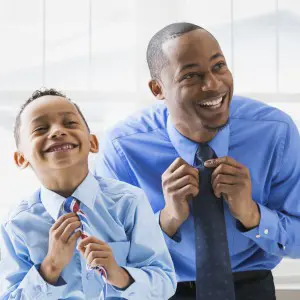 father and son tying their ties